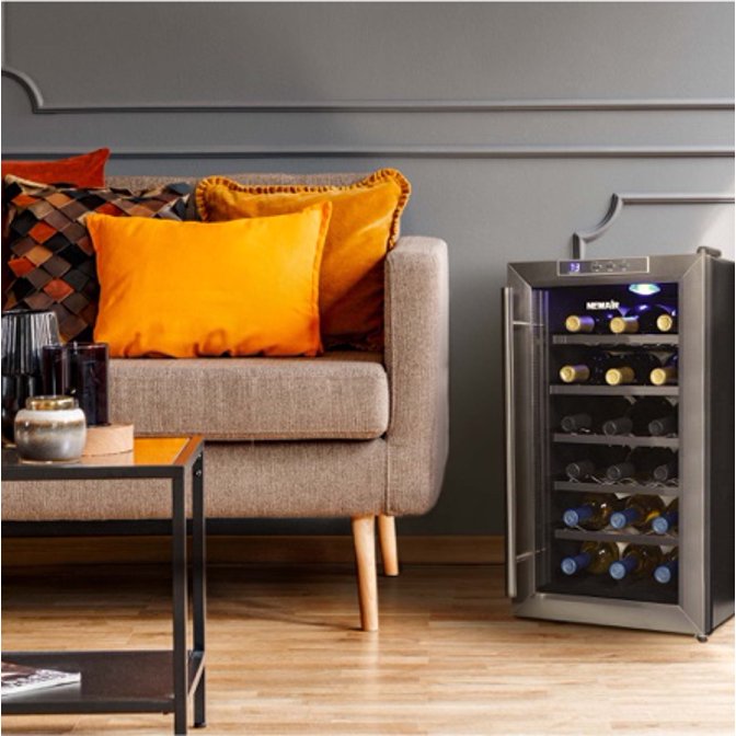 Wine cooler next to a sofa in a small-space living room. Links to where to shop wine coolers. 