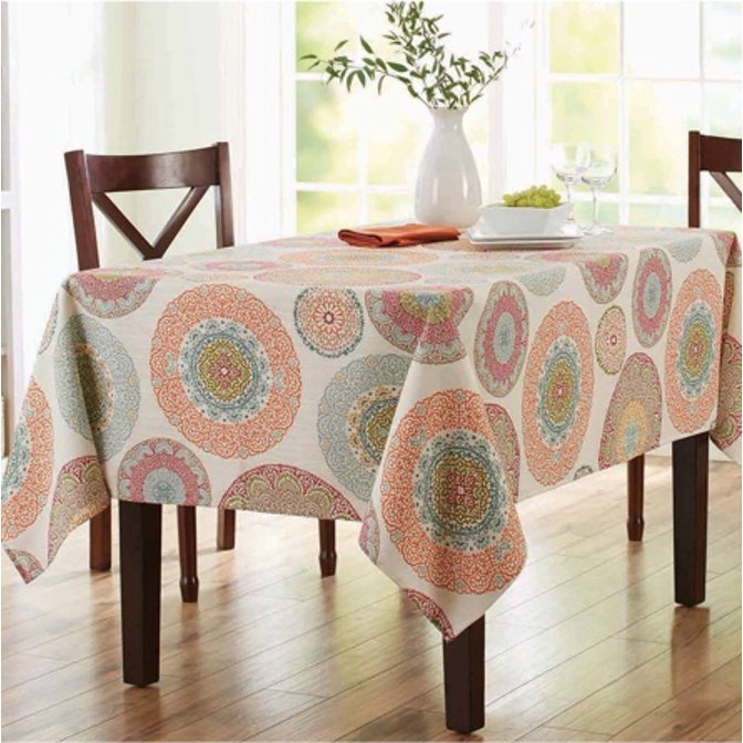 A tablecloth with a medallion pattern on a rectangular dining table. 